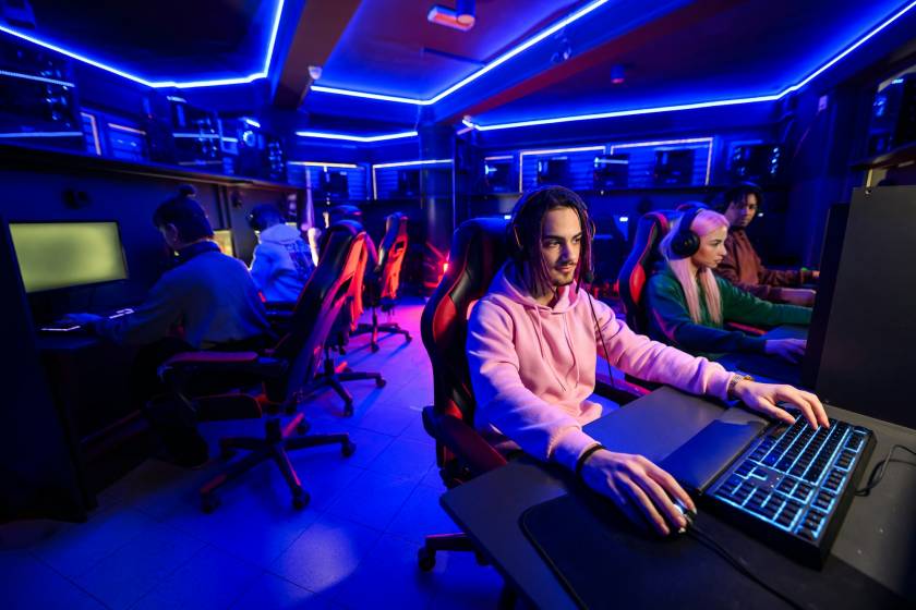 Professional esport team is practicing for tournament in cybercafe.