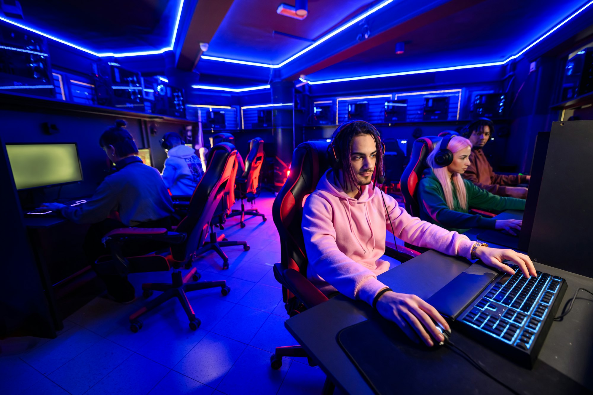 Professional esport team is practicing for tournament in cybercafe.